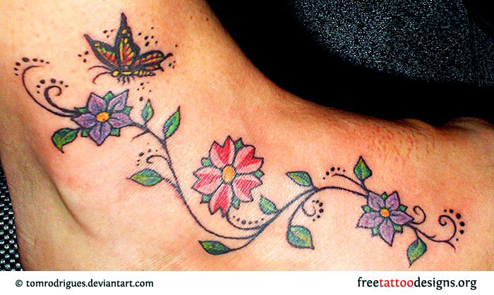 Colorful Flowers With Butterfly Tattoo On Right Foot