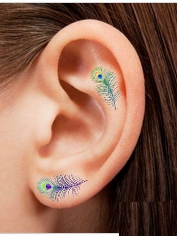 Colorful Two Peacock Feather Tattoo On Girl Left Ear