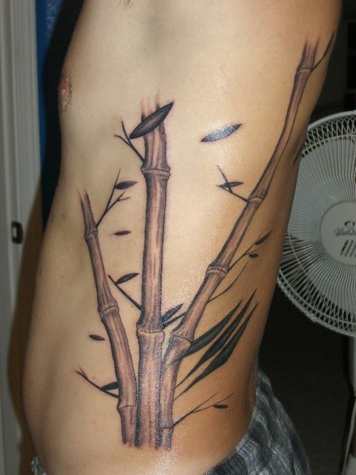 Cool Black Ink Bamboo Tree Tattoo On Man Left Side Rib