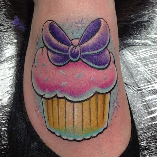 Cool Cupcake With Bow Tattoo On Right Foot By Craig Holmes
