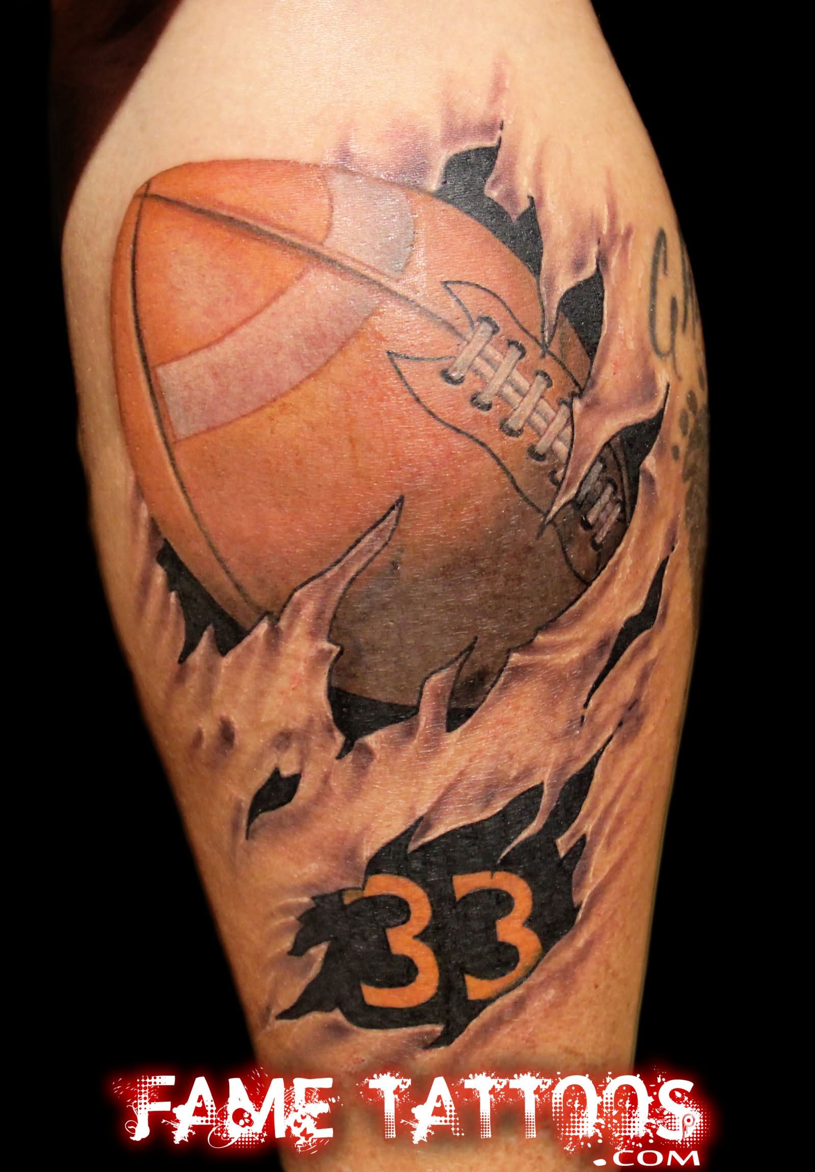 Cool Ripped Skin Football Tattoo On Leg Calf