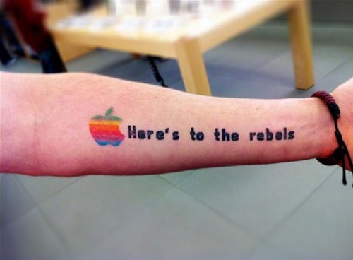 Here's To The Rebel - Colorful Apple Logo Tattoo On Left Forearm
