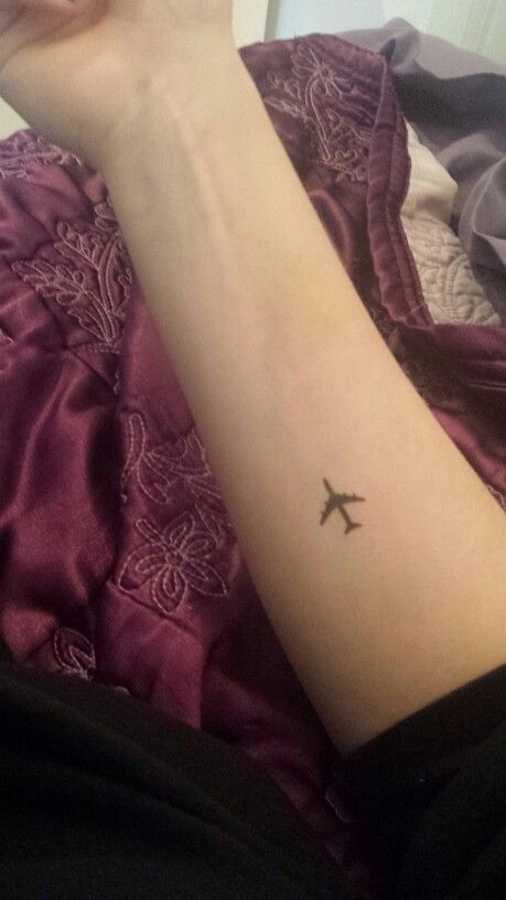 Little Black Airplane Tattoo On Right Forearm