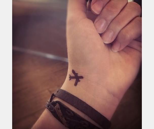 Little Silhouette Airplane Tattoo On Left Wrist