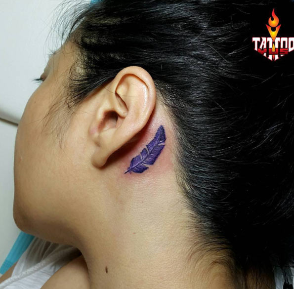 Purple Ink Feather Tattoo On Girl Left Behind The Ear