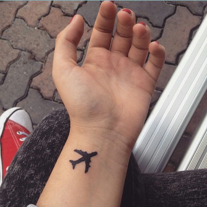 Silhouette Airplane Tattoo On Girl Left Wrist