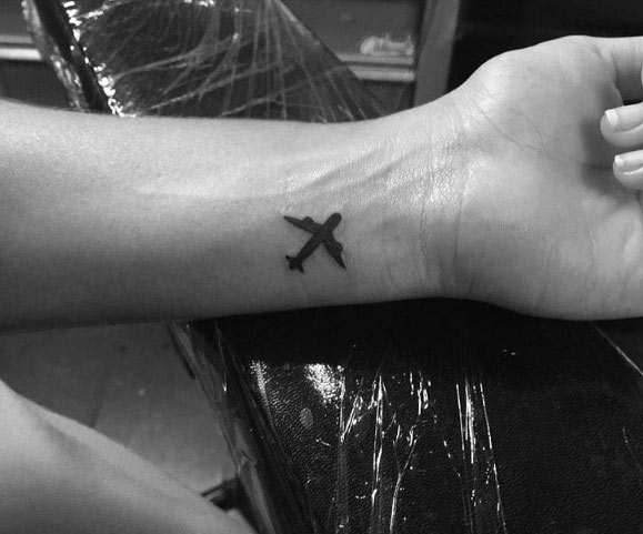 Silhouette Airplane Tattoo On Left Wrist