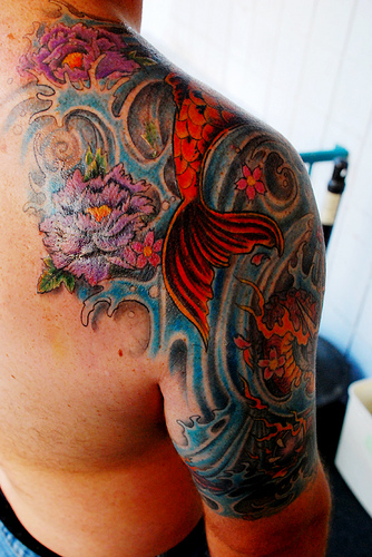 Traditional Asian Koi Fish With Flowers Tattoo On Right Shoulder