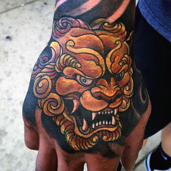 Traditional Foo Dog Head Tattoo On Man Right Hand