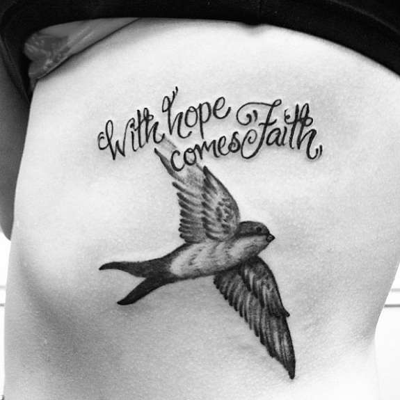 With Hope Come Faith - Black Ink Flying Bird Tattoo On Right Side Rib.