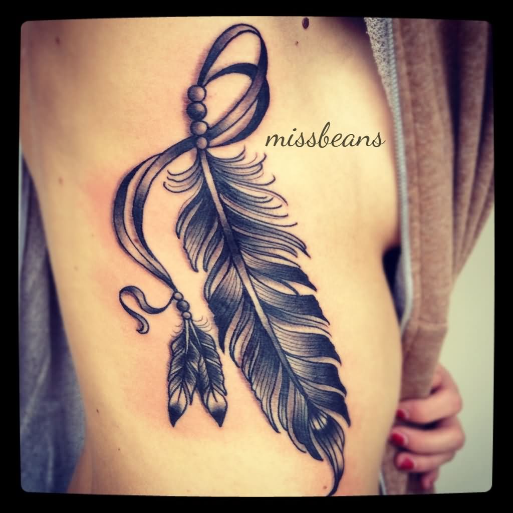 Wonderful Black Ink Feather Tattoo On Right Side Rib
