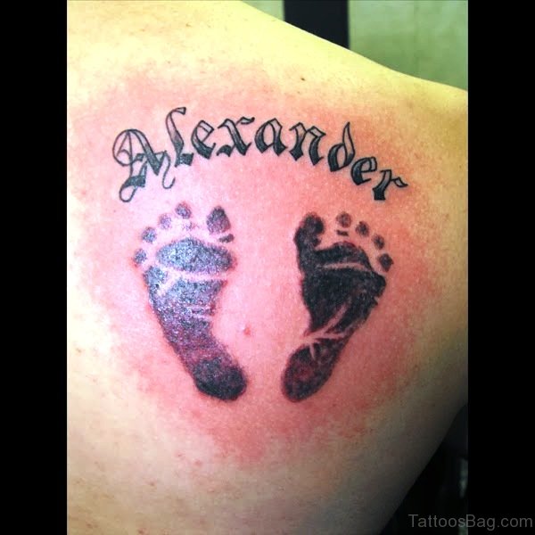 Alexander – Black Ink Footprints Tattoo On Right Back Shoulder