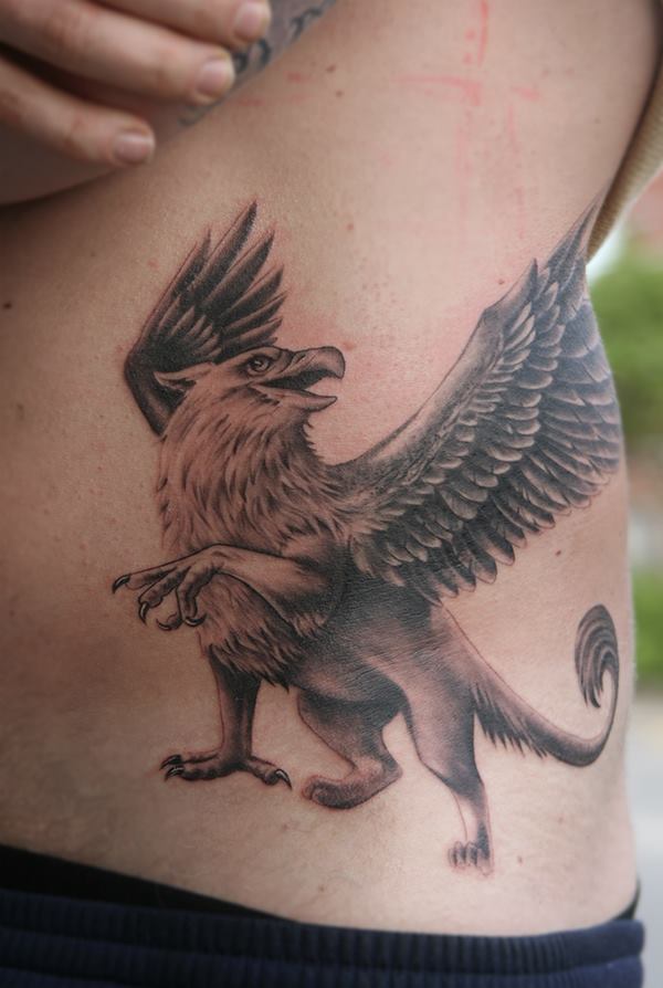 Attractive Black Ink Griffin Tattoo On Left Side Rib