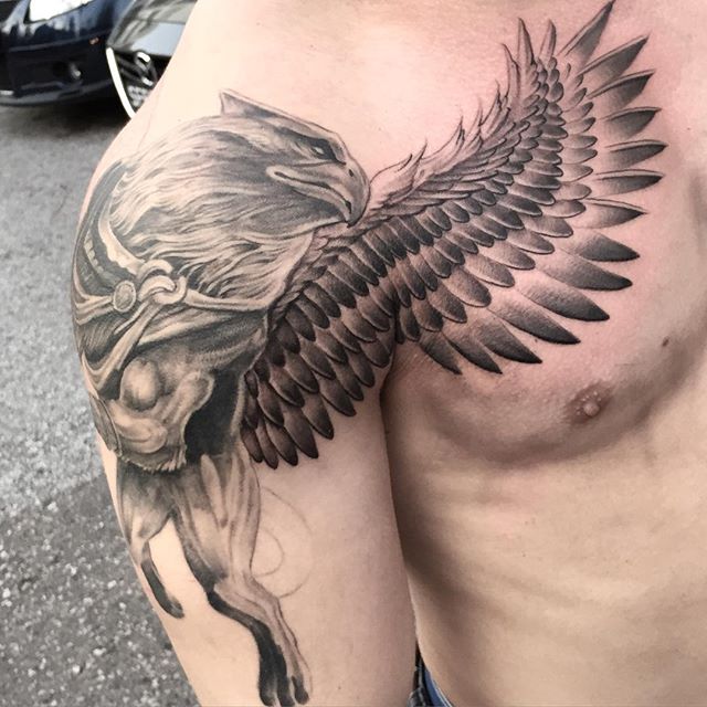 Attractive Black Ink Griffin Tattoo On Man Right Shoulder