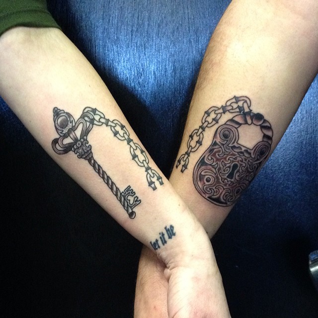 Attractive Black Ink Key And Lock Tattoo On Couple Forearm