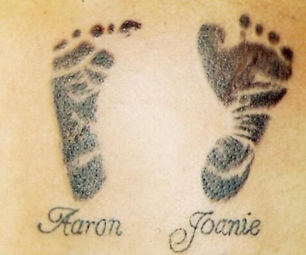 Awesome Black Ink Footprints Tattoo Design