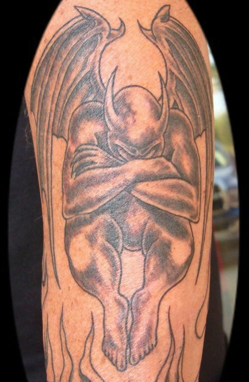 Awesome Black Ink Gargoyle Tattoo On Half Sleeve