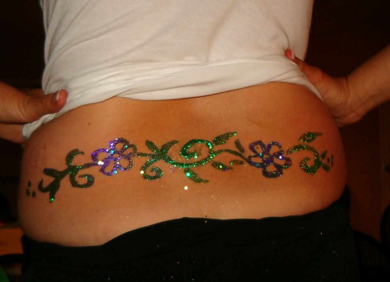 Awesome Colorful Glitter Flowers Tattoo On Lower Back