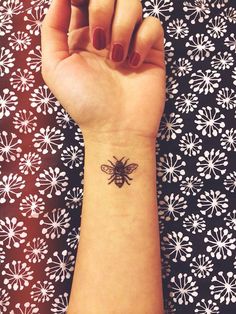 Black Ink Bee Tattoo On Girl Left Wrist