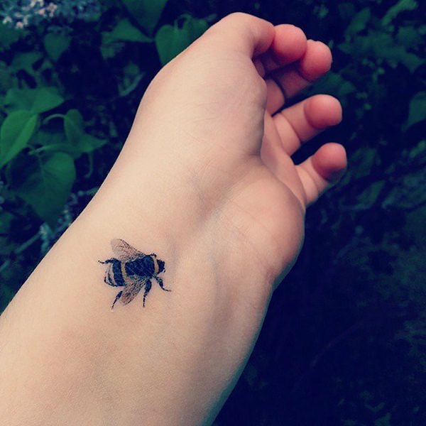 Black Ink Bee Tattoo On Left Wrist