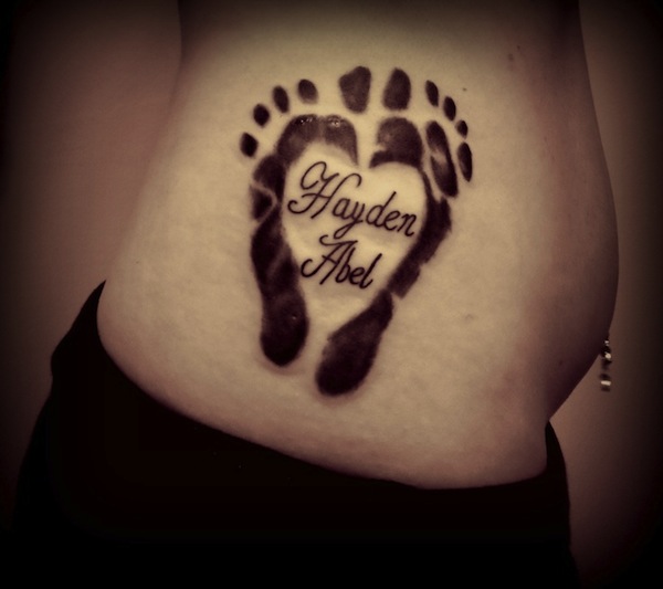 Black Ink Feet Prints Tattoo On Right Side Rib