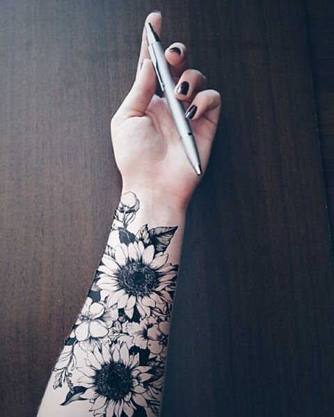 Black Ink Flowers Tattoo On Girl Left Forearm