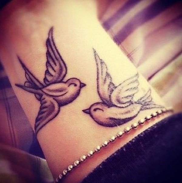 Black Ink Flying Birds Tattoo On Wrist