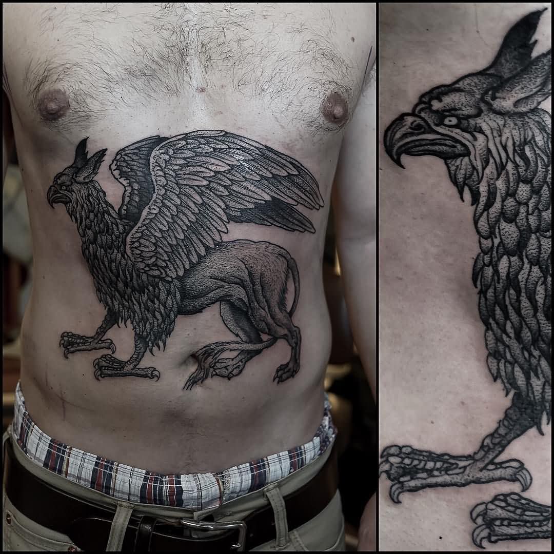 Black Ink Flying Griffin Tattoo On Man Stomach