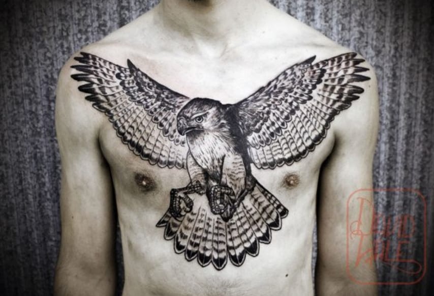 Black Ink Flying Hawk Tattoo On Man Chest