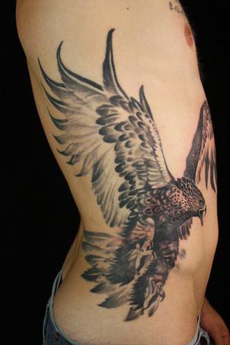 Black Ink Flying Hawk Tattoo On Man Right Side Rib