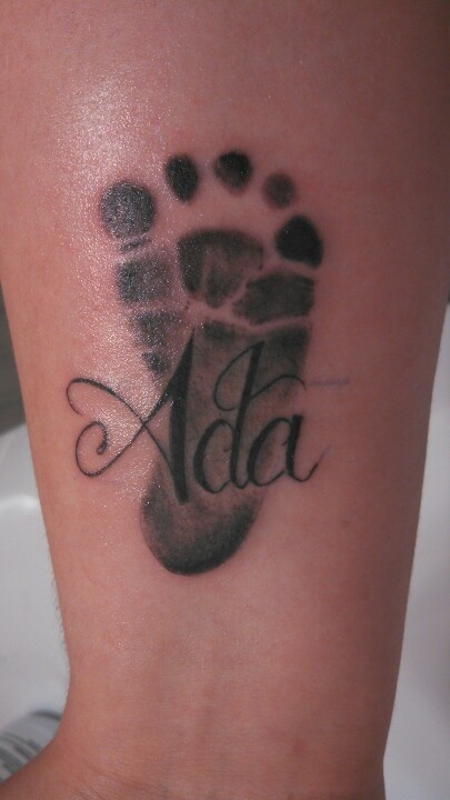 Black Ink Footprint Tattoo On Forearm