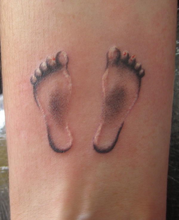 Black Ink Footprints Tattoo Design For Sleeve