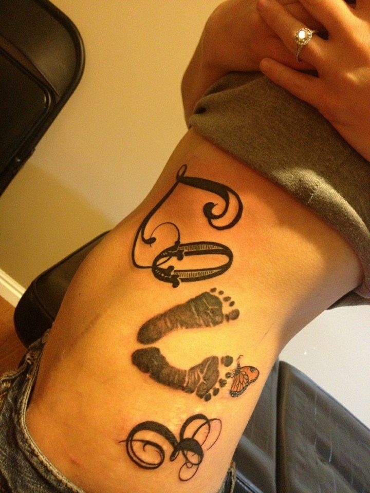 Black Ink Footprints Tattoo On Girl Left Side Rib