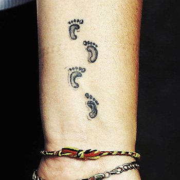 Black Ink Footprints Tattoo On Wrist