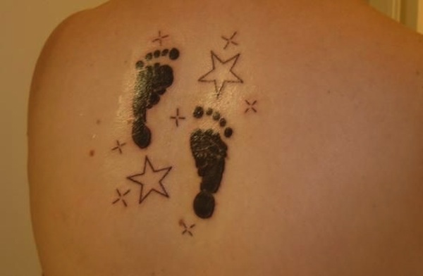 Black Ink Footprints With Stars Tattoo On Left Back Shoulder