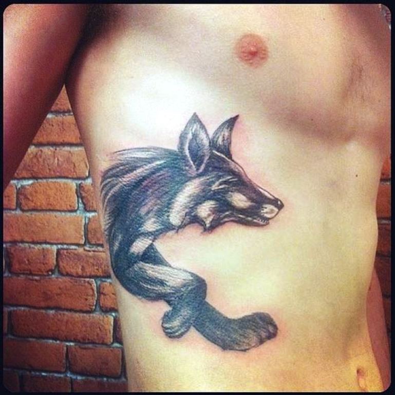 Black Ink Fox Tattoo On Man Right Side Rib