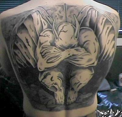 Black Ink Gargoyle Tattoo On Man Upper Back