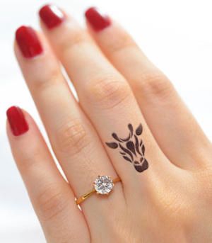 Black Ink Giraffe Head Tattoo On Girl Left Hand Finger