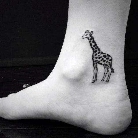 Black Ink Giraffe Tattoo On Left Ankle