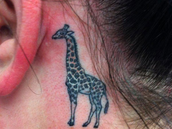 Black Ink Giraffe Tattoo On Left Behind The Ear