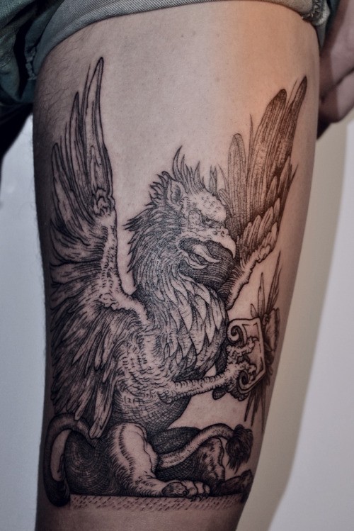 Black Ink Griffin Tattoo Design For Thigh
