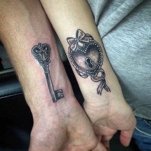 Black Ink Heart Shape Lock And Key Tattoo On Couple Wrist