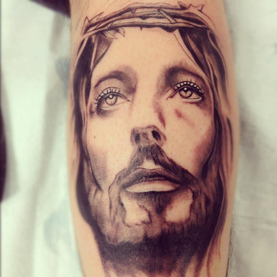 Black Ink Jesus Head Tattoo Design For Leg Calf