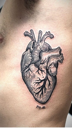 Black Ink Real Heart Tattoo On Man Left Side Rib