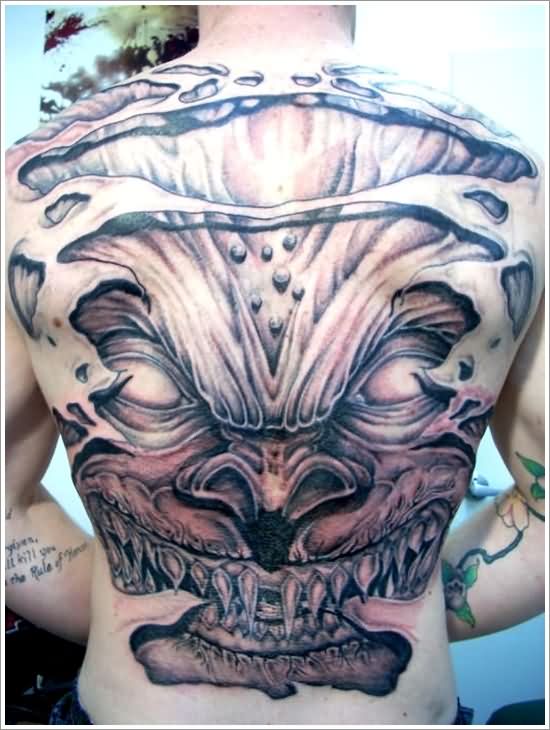 Black Ink Ripped Skin Goblin Head Tattoo On Man Full Back