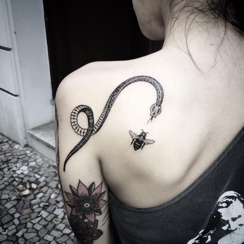 Black Ink Snake With Insect Tattoo On Left Back Shoulder