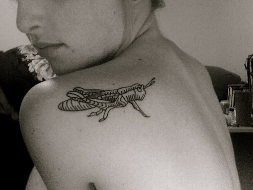 Black Outline Grasshopper Tattoo On Left Back Shoulder
