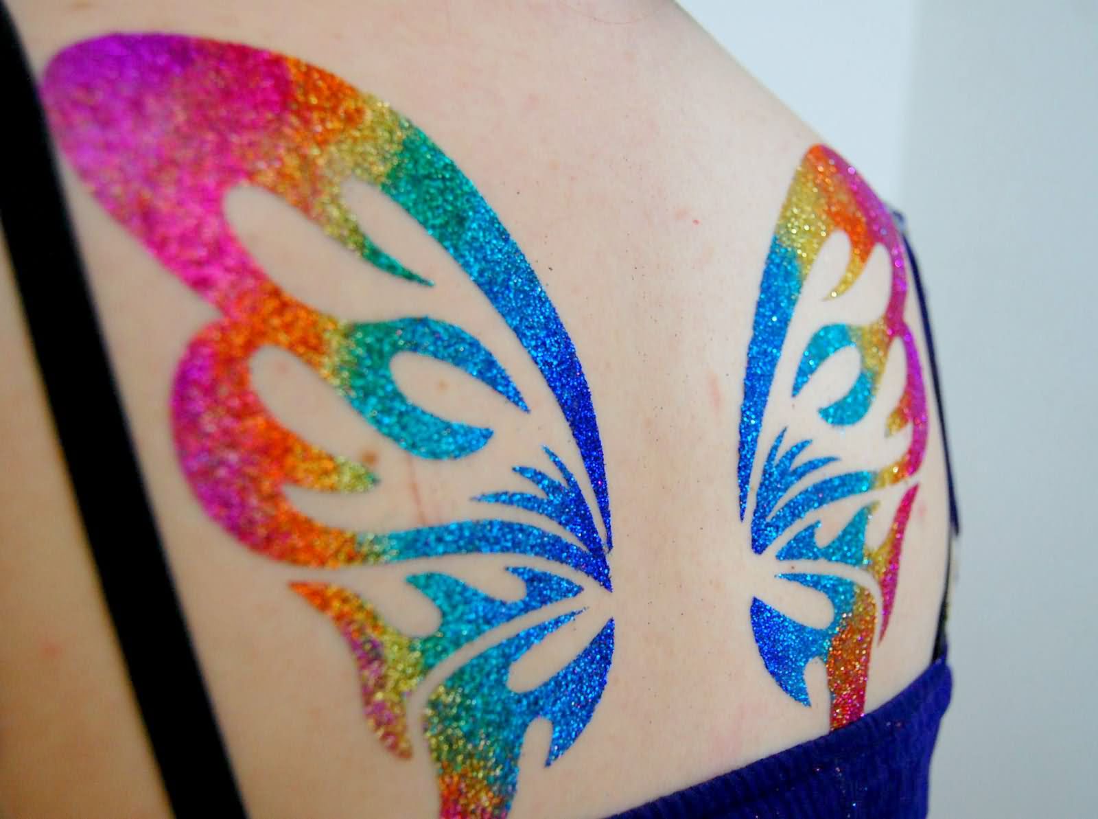 Colorful Glitter Butterfly Wings Tattoo On Women Upper Back