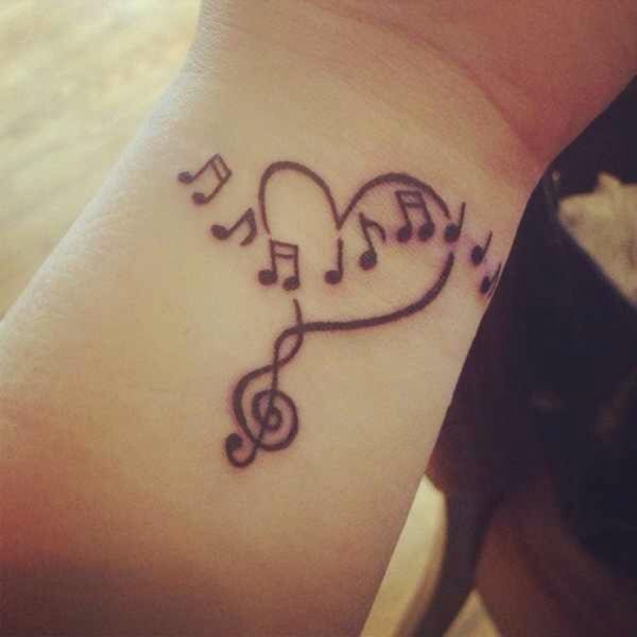 Cool Black Outline Heart With Music Knots Tattoo On Wrist