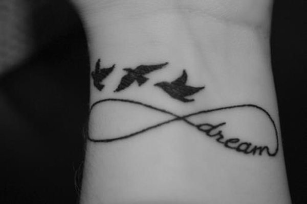 Dream – Black Ink Infinity With Flying Birds Tattoo On Wrist